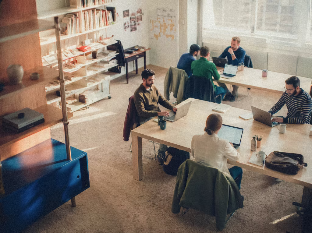 Official Base44 student page image showing students building together in a shared workspace